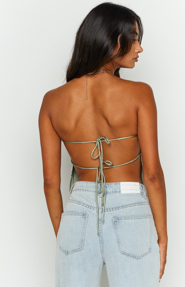 Rear view of the olive satin strapless top showing the delicate criss-cross tie-back detail