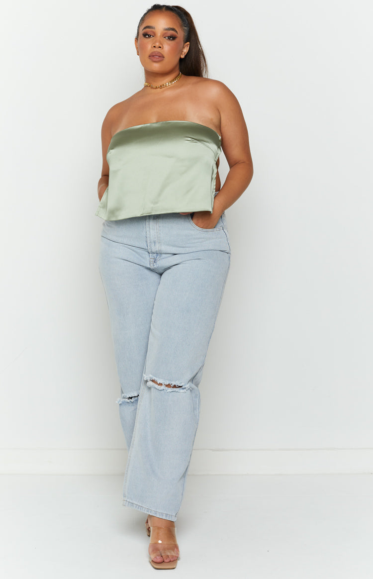 Front view of a cropped olive satin strapless top with a relaxed fit