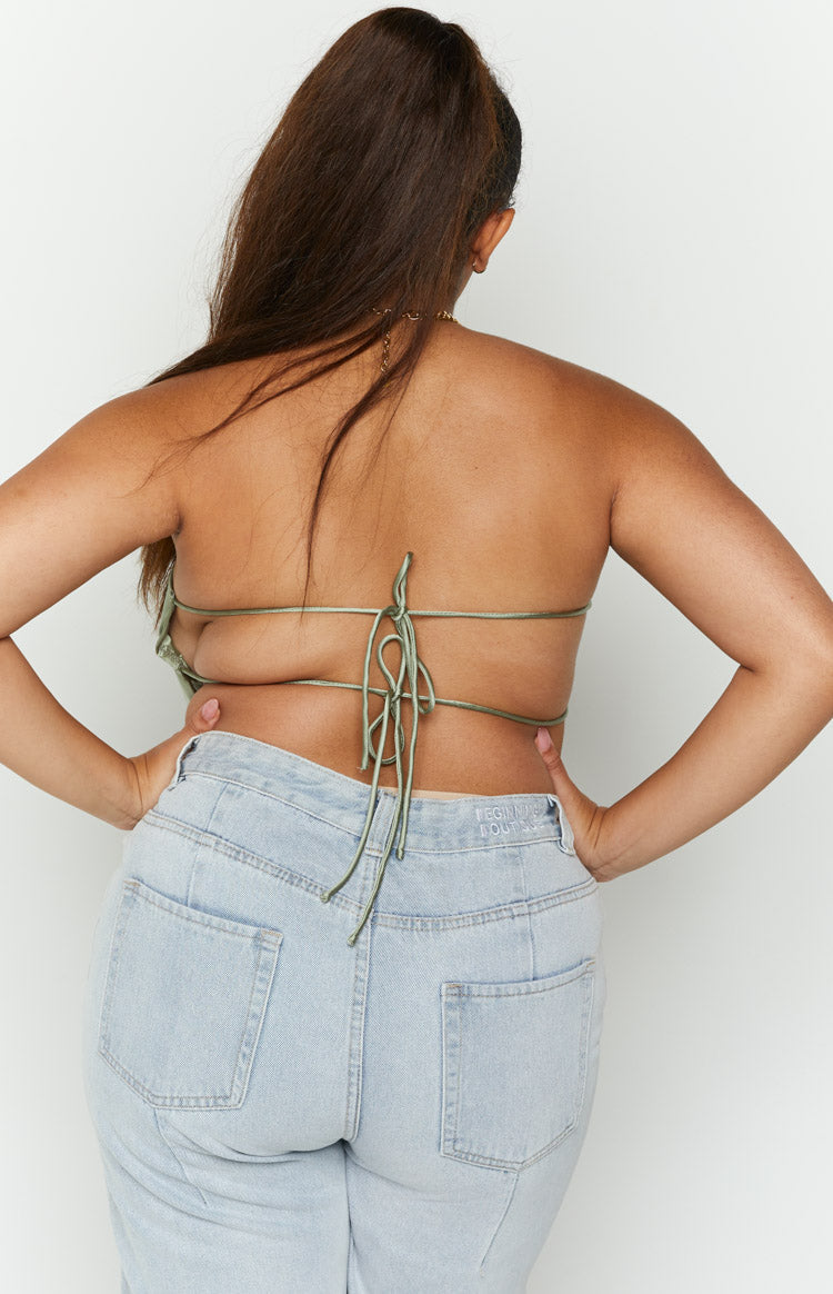 Rear view of an olive satin strapless top with multiple thin tie-back straps