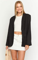brunette model wearing a black blazer