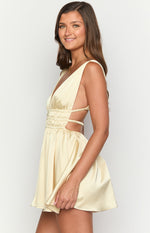 Side view of the yellow satin mini dress showing the deep V-neckline and ruched cutouts at the waist
