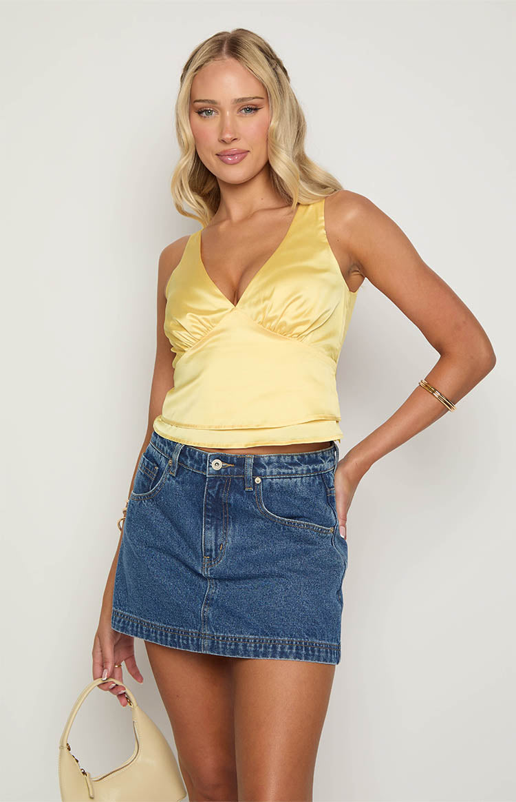 Yellow satin V-neck top with gathered bust detail and a fitted waist