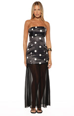 Full front view of a black polka dot maxi dress with a strapless satin mini dress bodice and a sheer black maxi skirt overlay