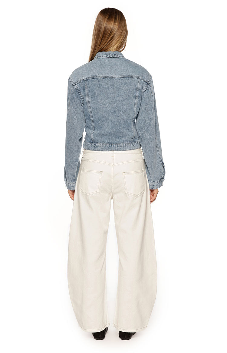 Rear view of a mid-wash denim jacket showing the cinched elasticated waist and back yoke