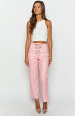 Pink PU leather high-waisted pants with a lace-up front detail and straight cropped legs