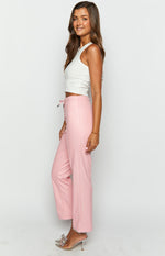 Side view of pink PU leather straight leg pants with a lace-up detail on the side waist