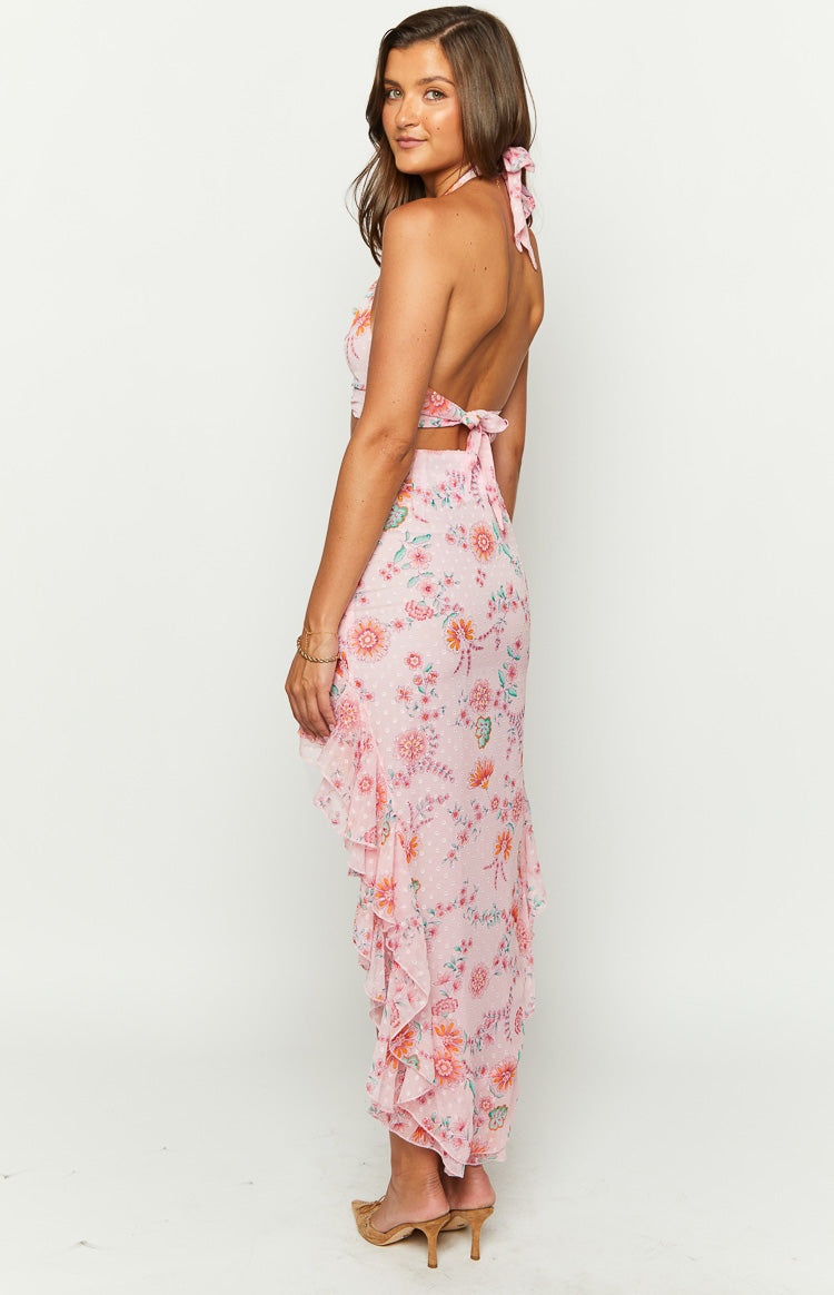 Side view of a pink floral maxi skirt with a high-low hem and cascading ruffled layers