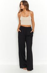 Front view of a beige rib knit cropped singlet top with thin spaghetti straps and a fitted silhouette