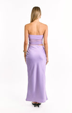 Rear view of a lilac satin maxi dress with a strapless top, sheer mesh panels on the back, and a cutout waist detail