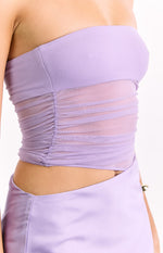 Close-up of the sheer ruched mesh midriff panel and waist cutout on the lilac strapless maxi dress
