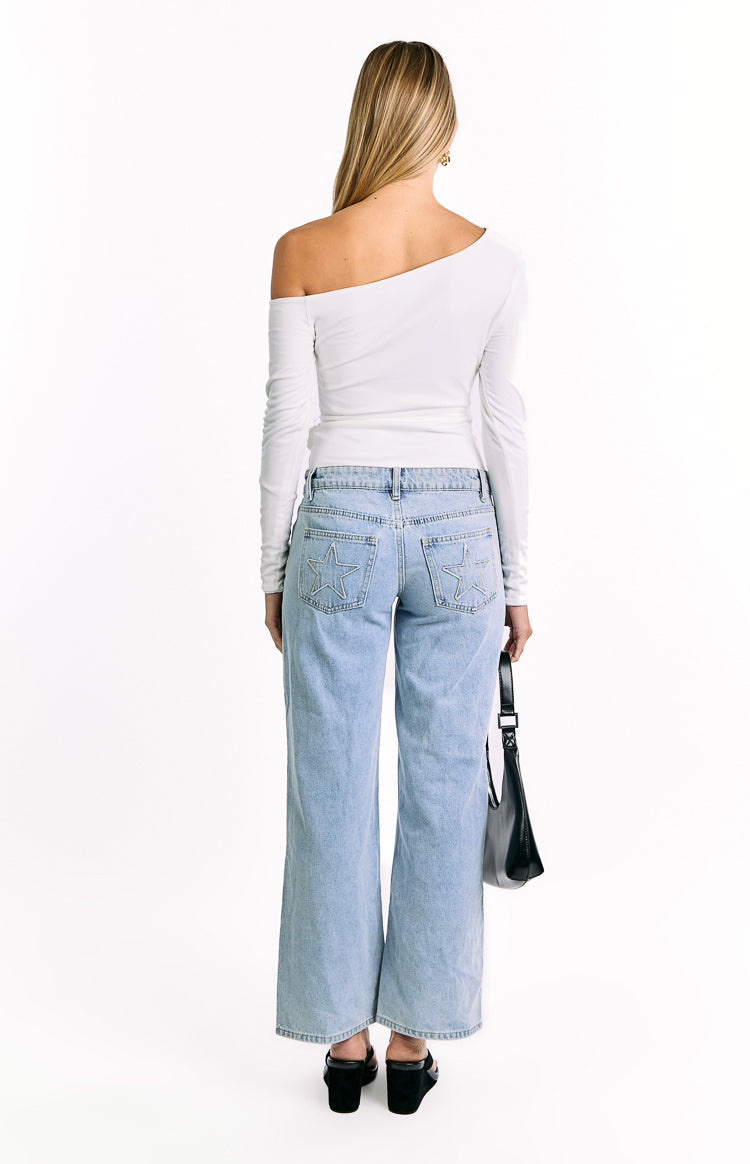Rear view of a white fitted long sleeve top with an asymmetrical off-shoulder neckline