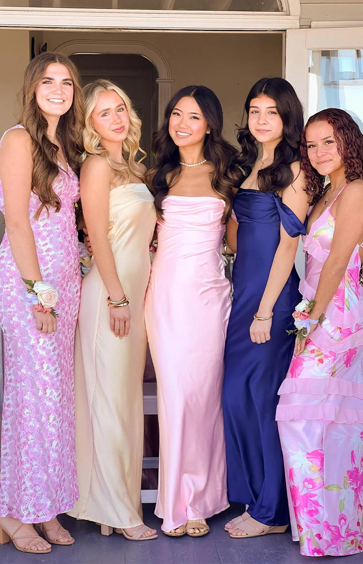 Light pink satin off-shoulder maxi dress with a ruched bodice and fitted silhouette