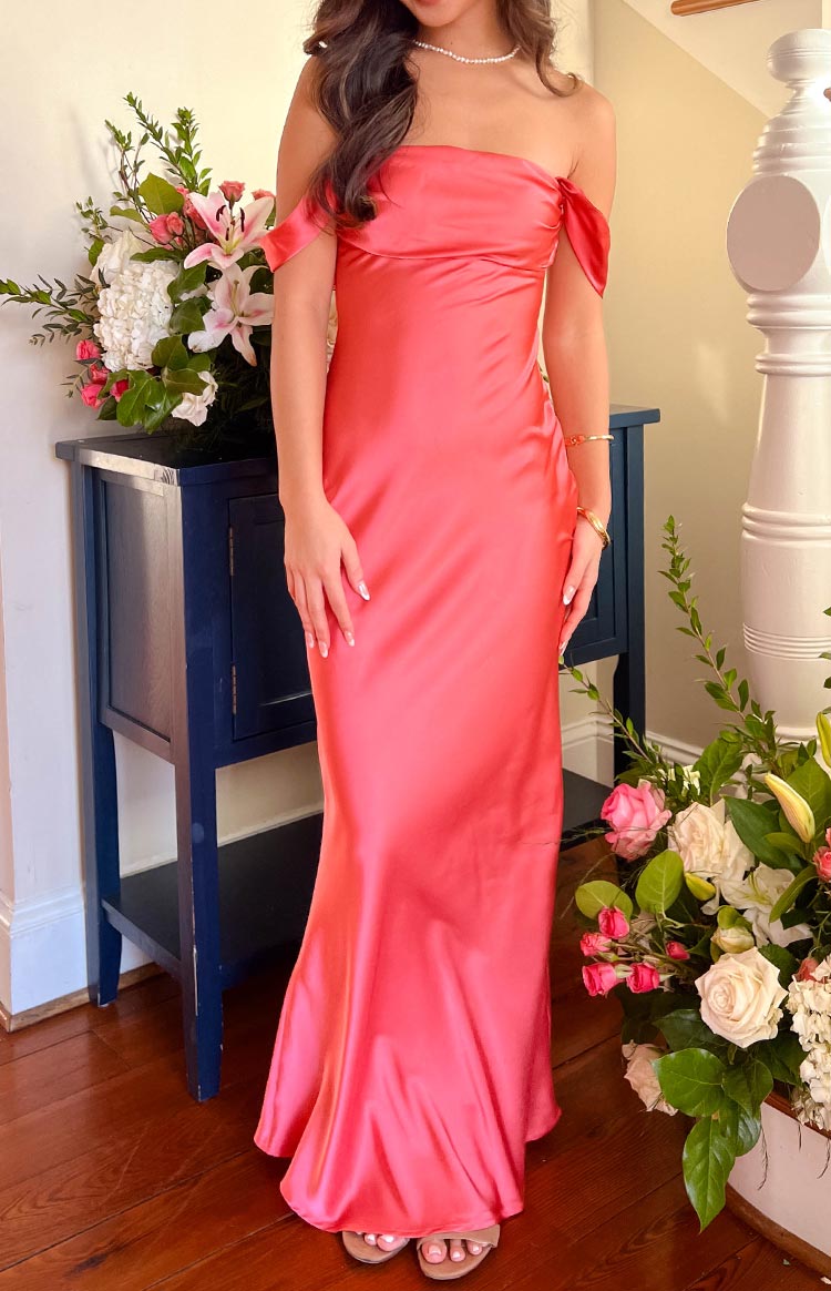 Full-length pink satin off-shoulder formal dress with a draped neckline and a flowing column skirt