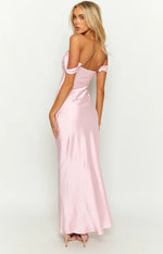 Rear-side view of a light pink satin off-shoulder maxi dress with a low back and flowing skirt