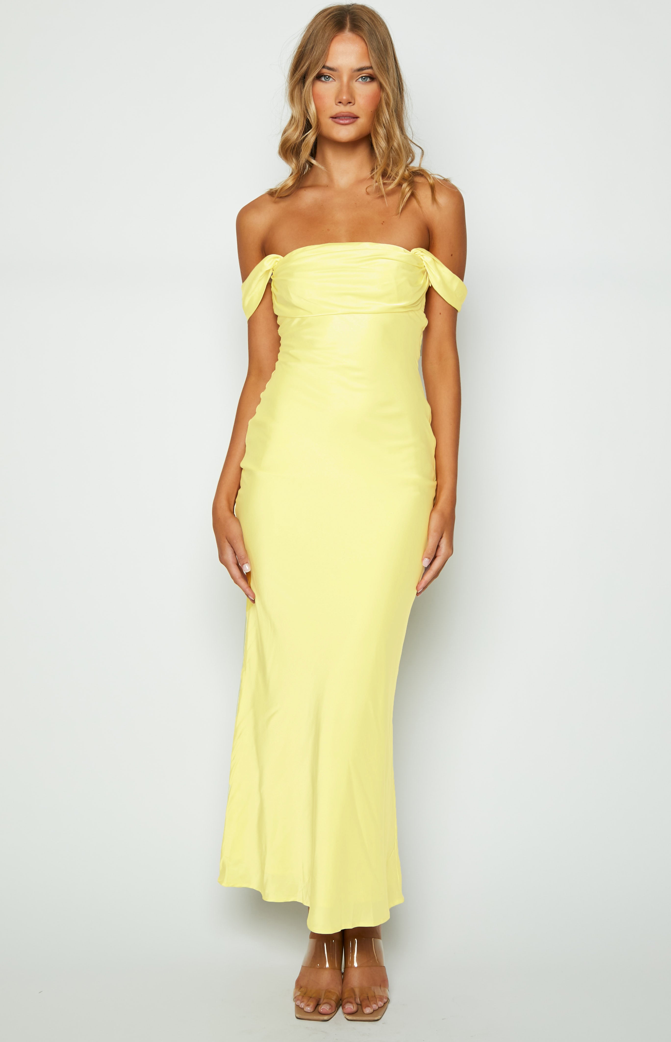 Light yellow off-shoulder maxi dress with a draped bodice and a smooth, flowing skirt