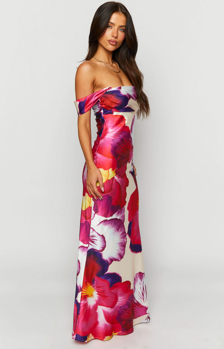 Side view of a pink floral print off-shoulder maxi dress with a draped neckline and fitted silhouette