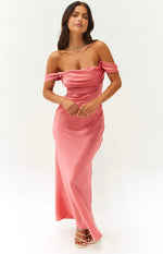 Front view of a pink off-shoulder formal dress with a draped bodice and flowing maxi skirt