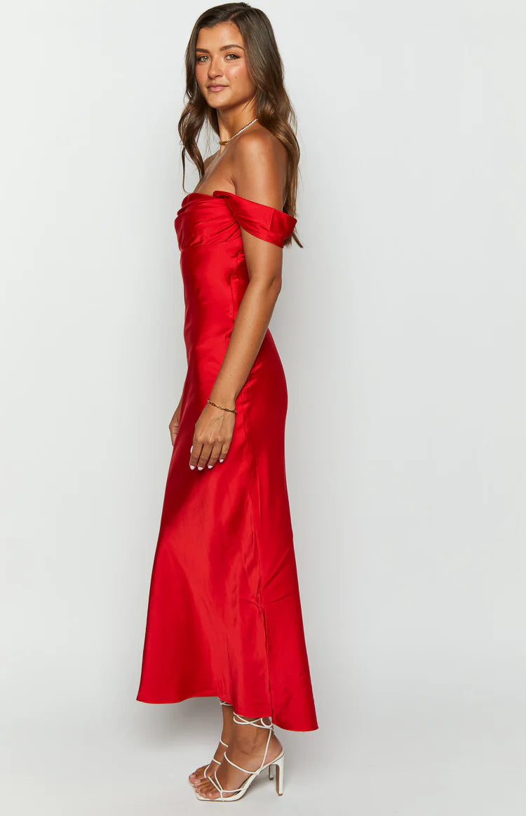Side view of a red satin off-shoulder formal dress with a draped bodice and a fitted midi skirt