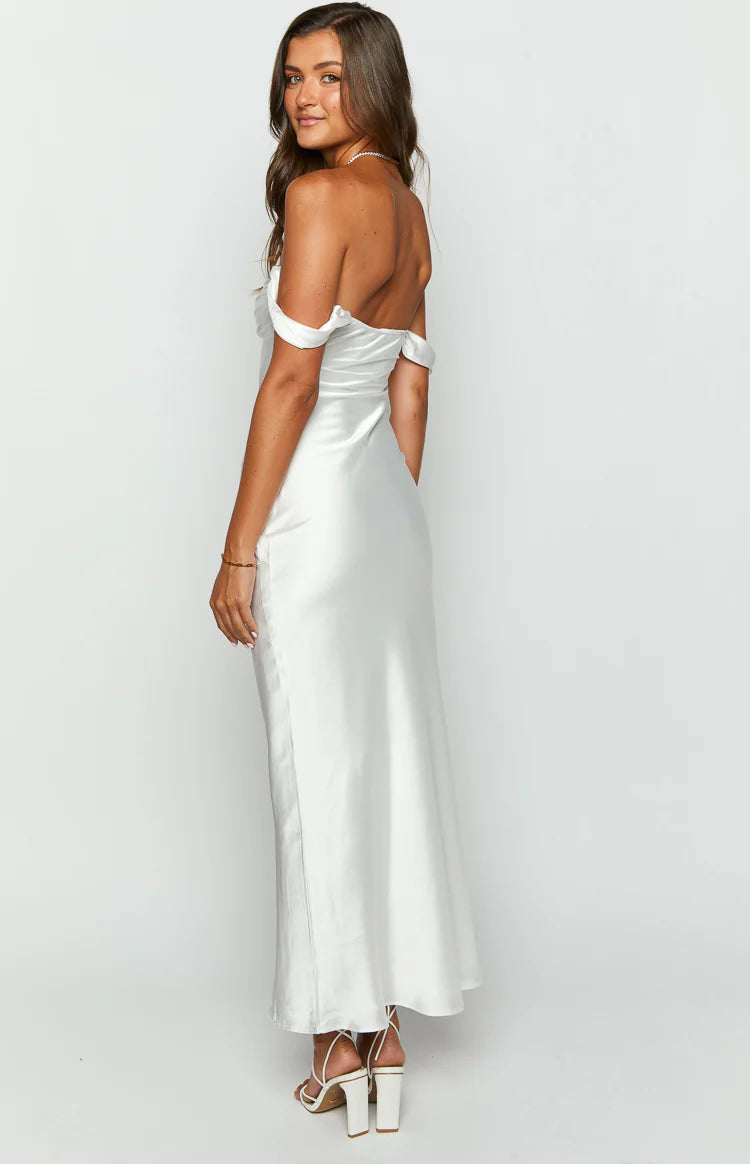 Rear-side view of a white satin off-shoulder formal dress showing the draped sleeves and flowing maxi skirt