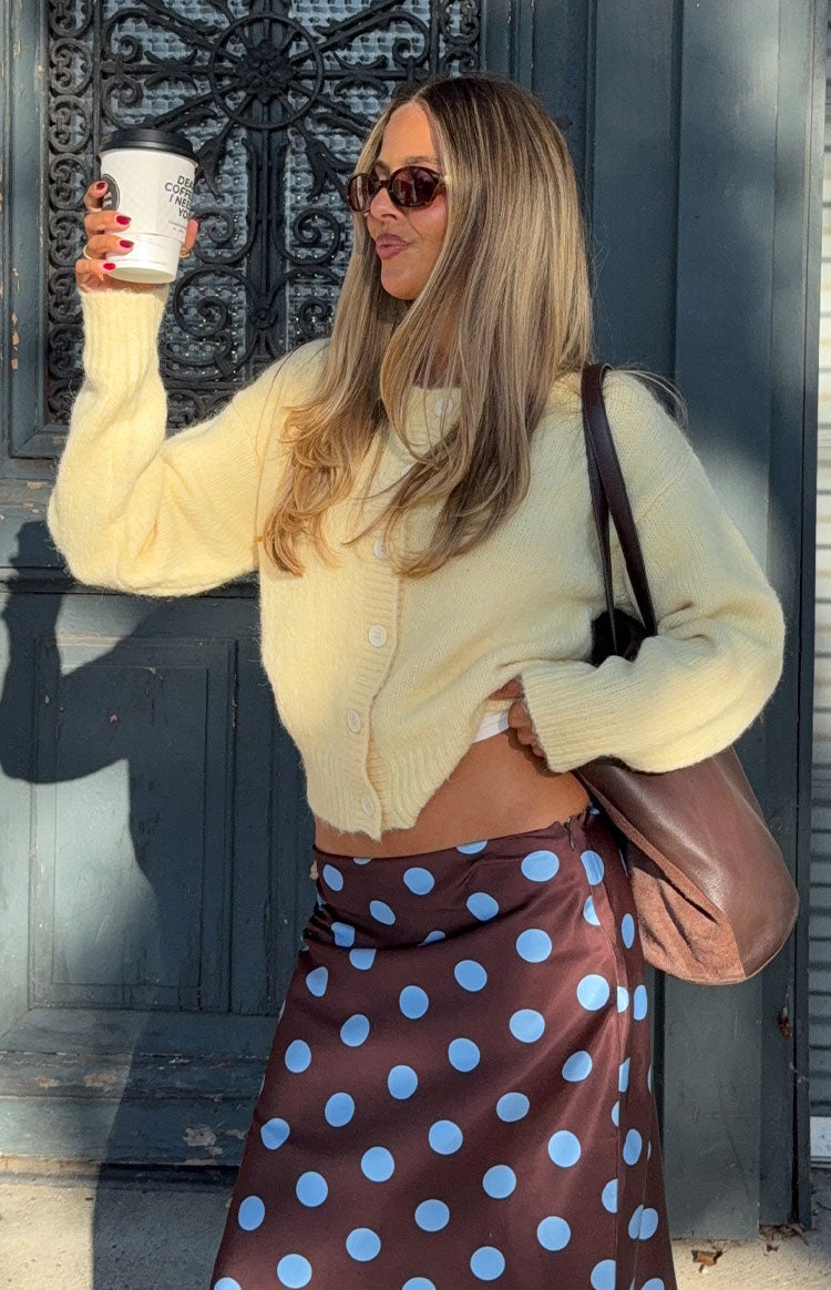 Butter yellow fuzzy knit cardigan with a button-down front, long sleeves, and cropped hem