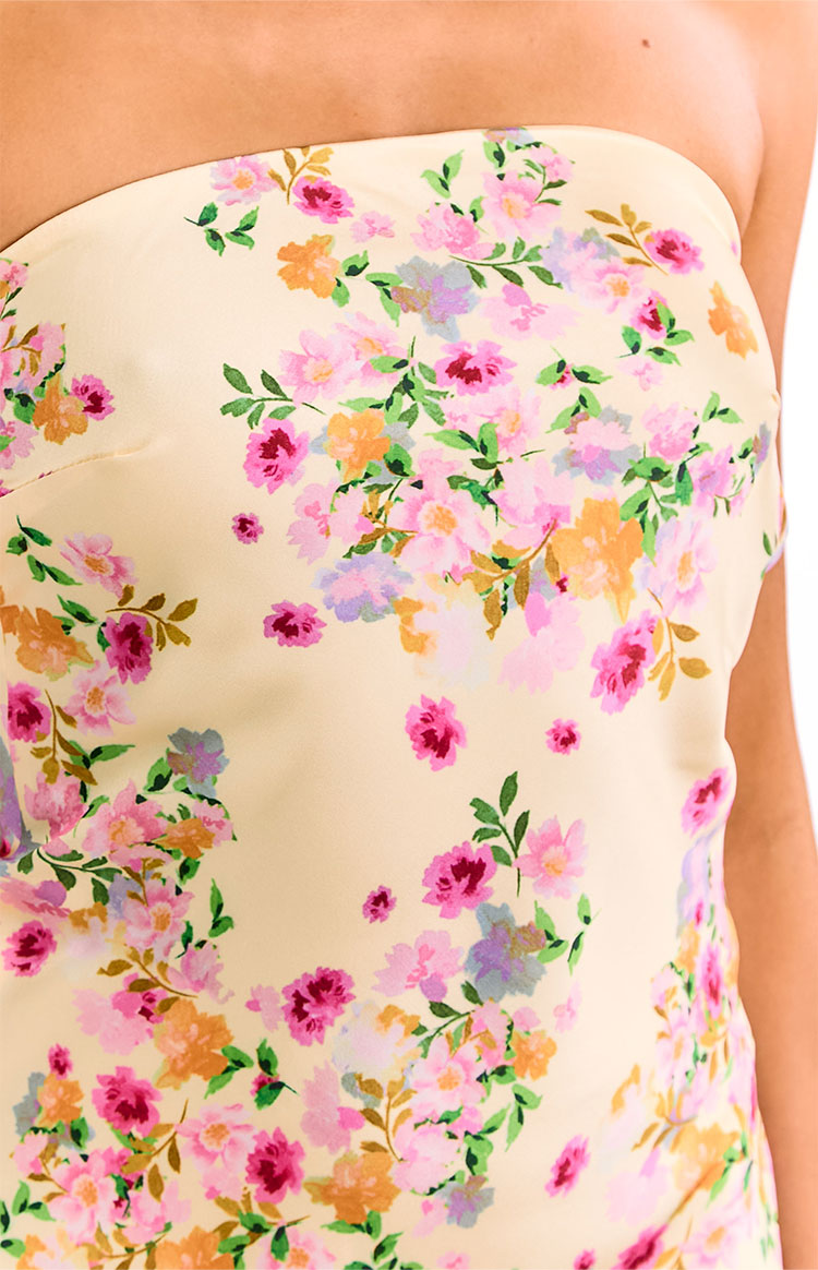 Close-up of the yellow strapless mini dress bodice with a pink, purple, and orange bloom floral print