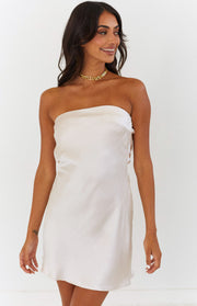 Cream strapless satin mini dress with a subtle sheen and delicate lace-up detail on the side