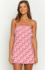 Front view of a strapless mini dress with a pink and red speckled floral pattern