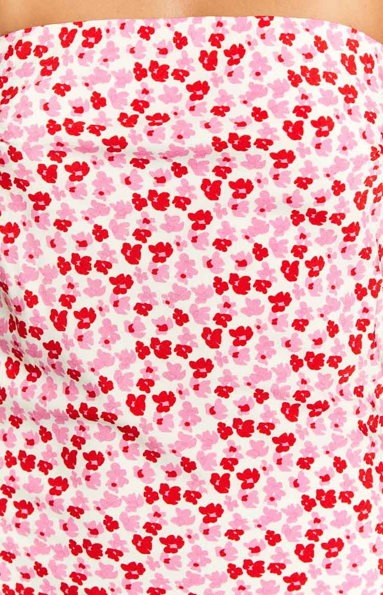 Close-up of the white fabric with a speckled pattern of small pink and red flowers