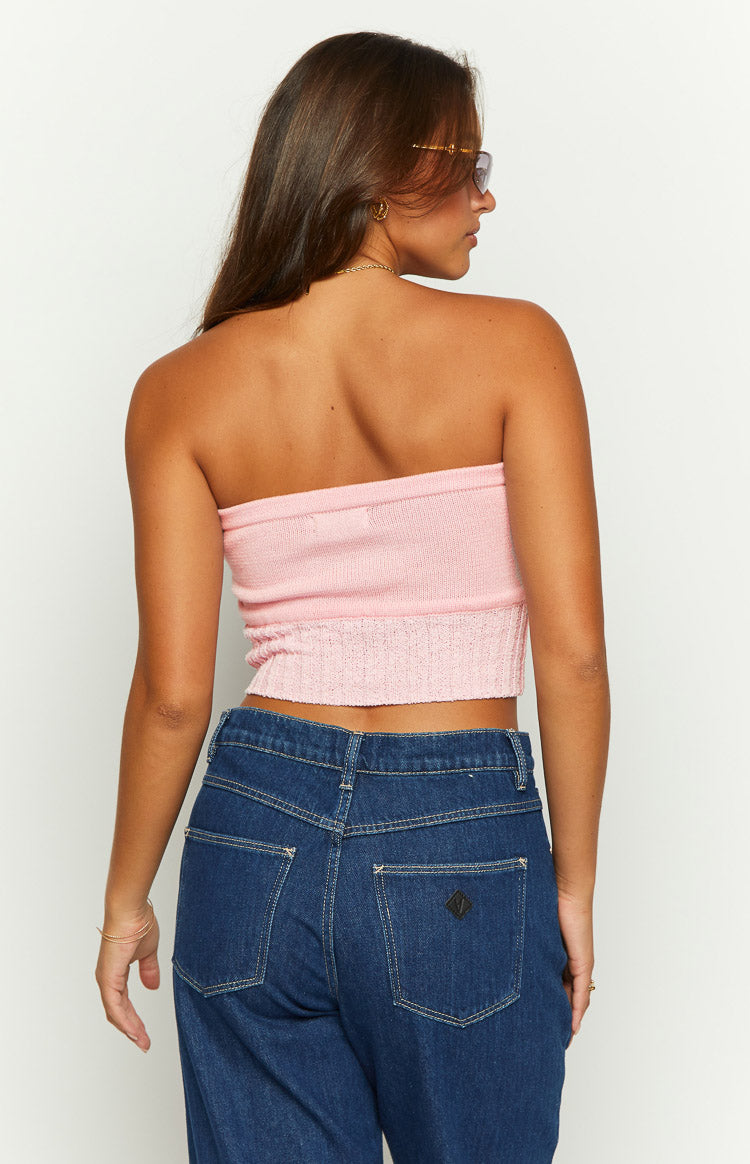 Rear view of a pink knit tube top with a ribbed texture and cropped elasticated hem