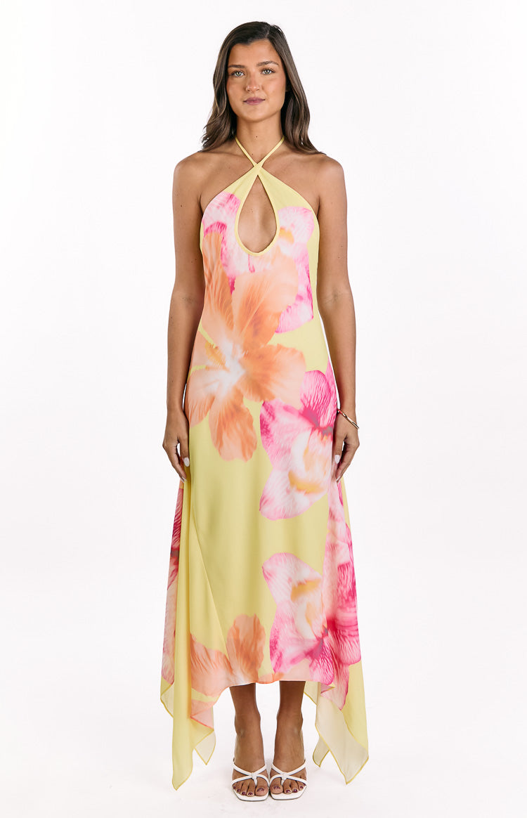 Flowy yellow hibiscus floral maxi dress with a halter neckline and asymmetric handkerchief hem