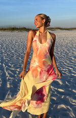 Flowy yellow hibiscus floral maxi dress with a ruffled halter neckline and full skirt