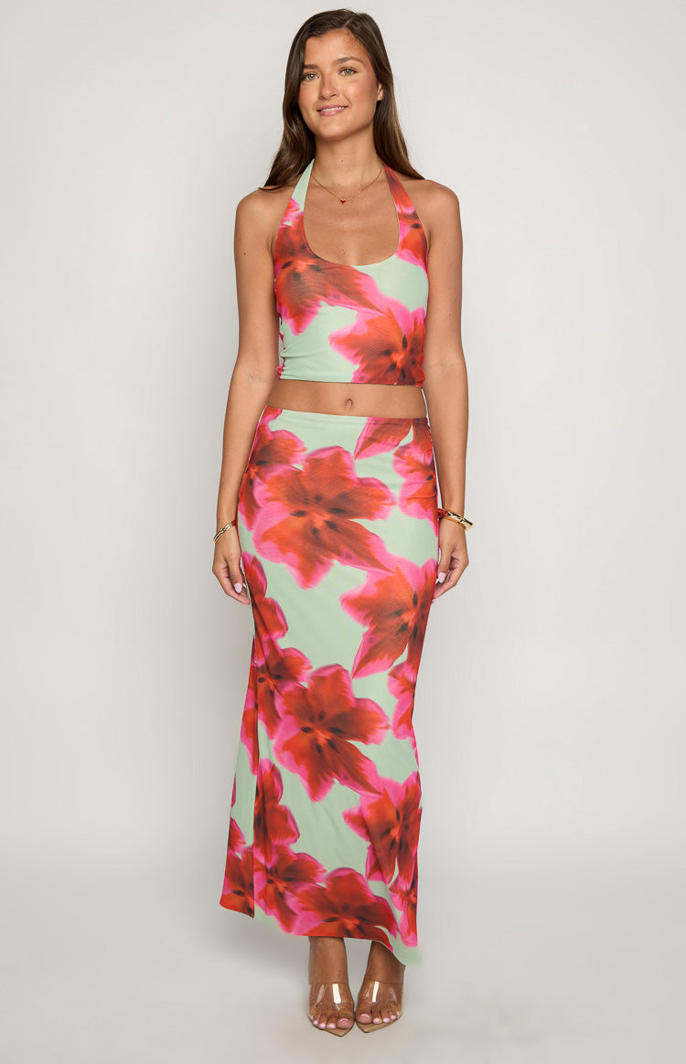 Full length front view of a green and pink floral cropped halter top with a scoop neckline