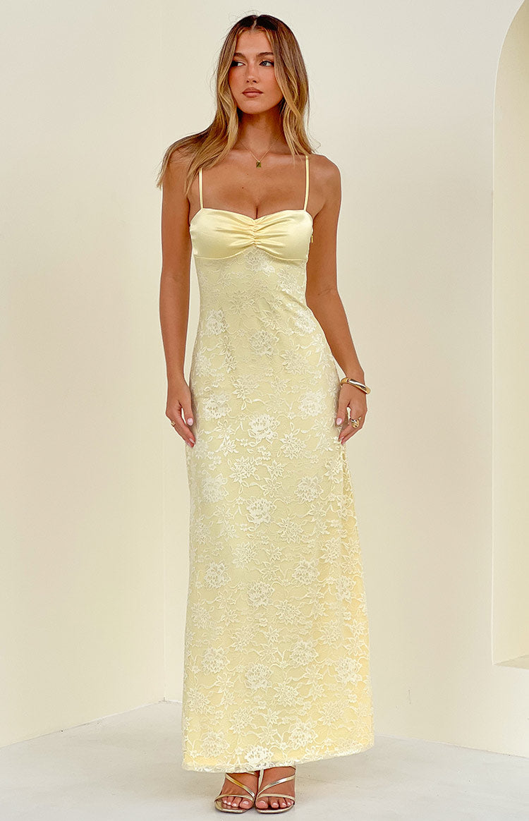 Front view of a yellow floral lace maxi dress with spaghetti straps and a ruched bust