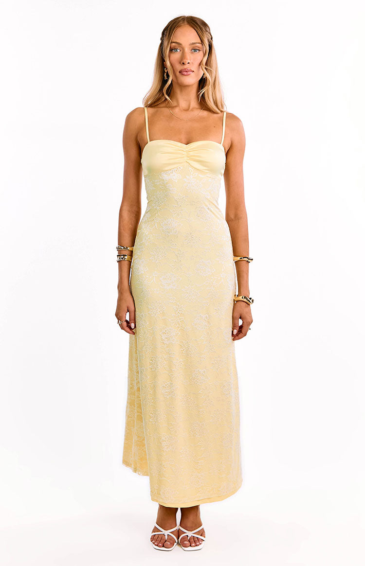 Full length front view of a yellow lace maxi dress with spaghetti straps and a ruched bust