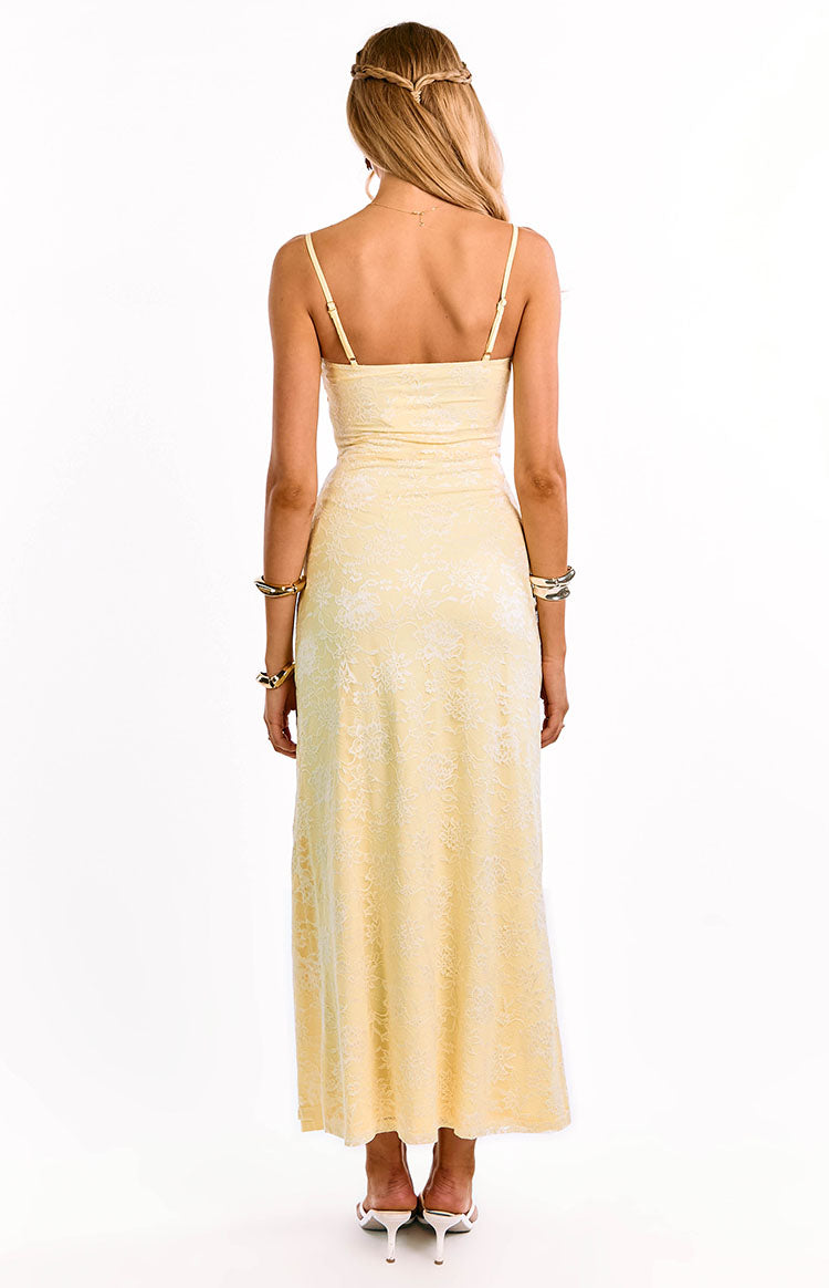 Back view of a yellow lace maxi dress with a delicate floral pattern and thin adjustable spaghetti straps