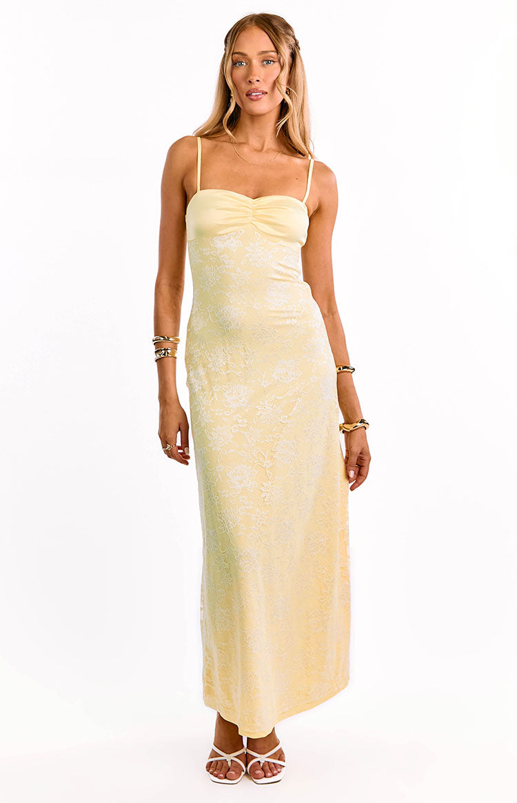 Front view of a yellow lace maxi dress with a ruched bust and thin spaghetti straps