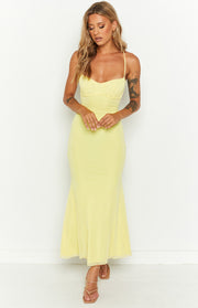 Front view of a yellow maxi dress with a ruched sweetheart neckline, thin spaghetti straps, and a fitted silhouette