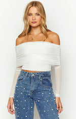 Close-up of the ruched off-shoulder neckline and sheer long sleeves of a white mesh crop top