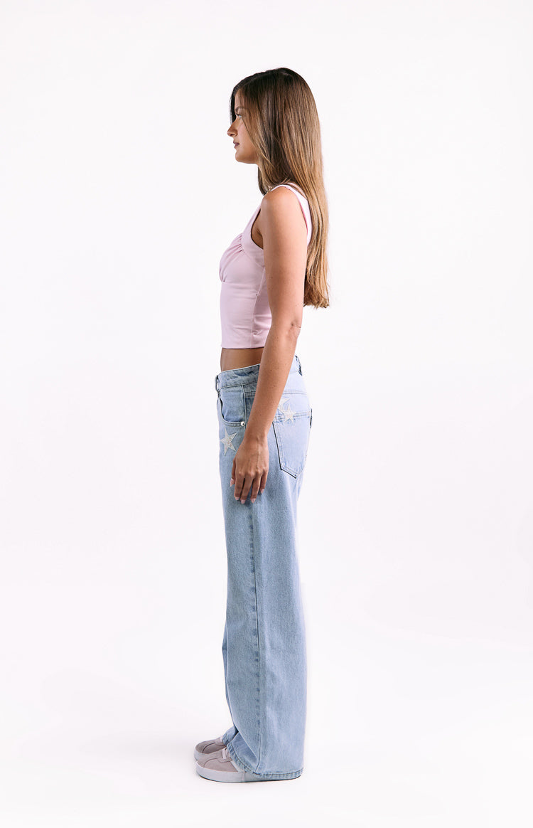 Side view of a pink cropped top with a ruched bust and thick shoulder straps
