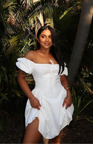 Beginning Boutique Emma White Puff Sleeve Mini Dress white off-shoulder mini dress with puff sleeves, a drawstring bust, and gathered skirt