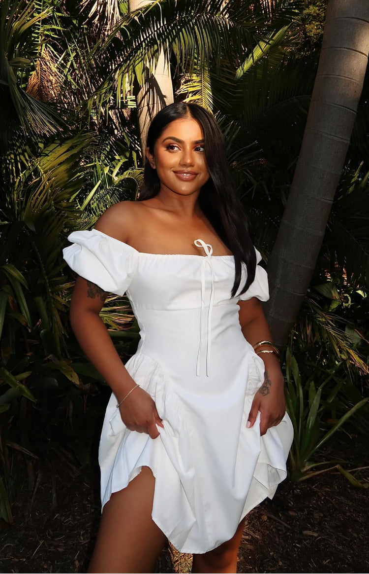 Beginning Boutique Emma White Puff Sleeve Mini Dress white off-shoulder mini dress with puff sleeves, a drawstring bust, and gathered skirt