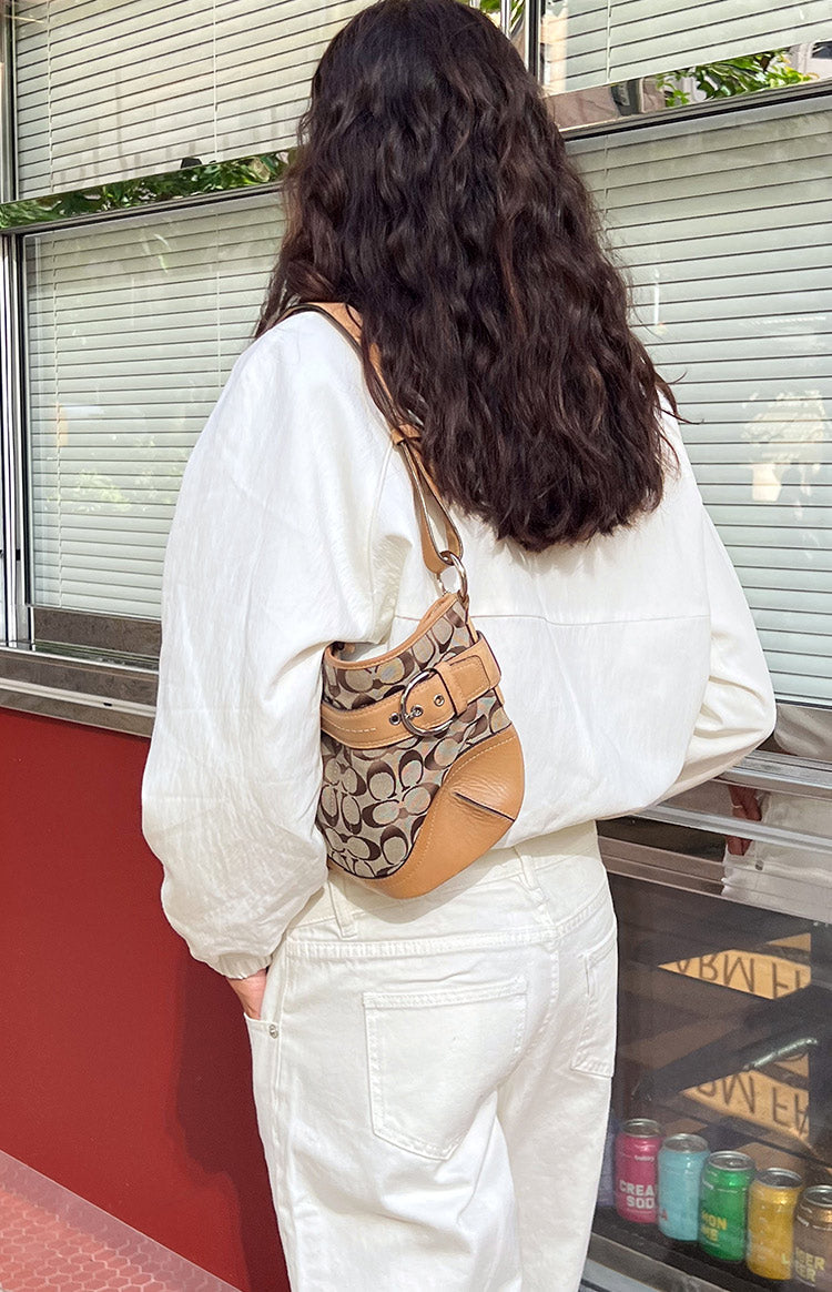 Rear view of the cream funnel neck sports jacket showing the relaxed fit and long sleeves with elasticated cuffs