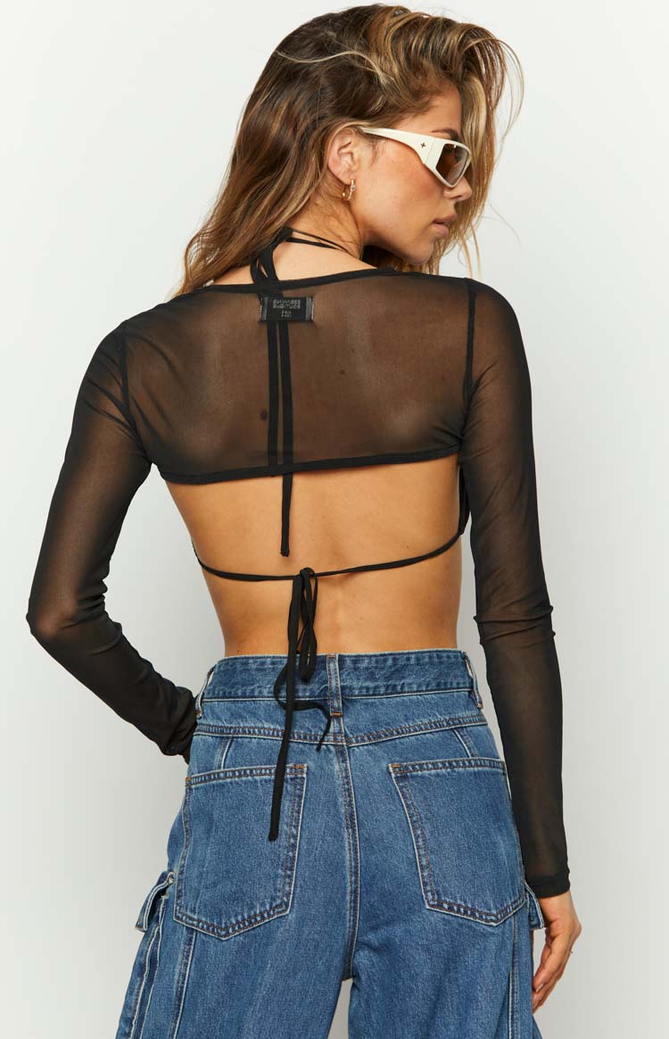 Rear view of a black sheer mesh long sleeve crop top with an open back and tie closure