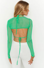 Rear view of the green mesh long sleeve crop top with open back, halter neck tie, and waist tie