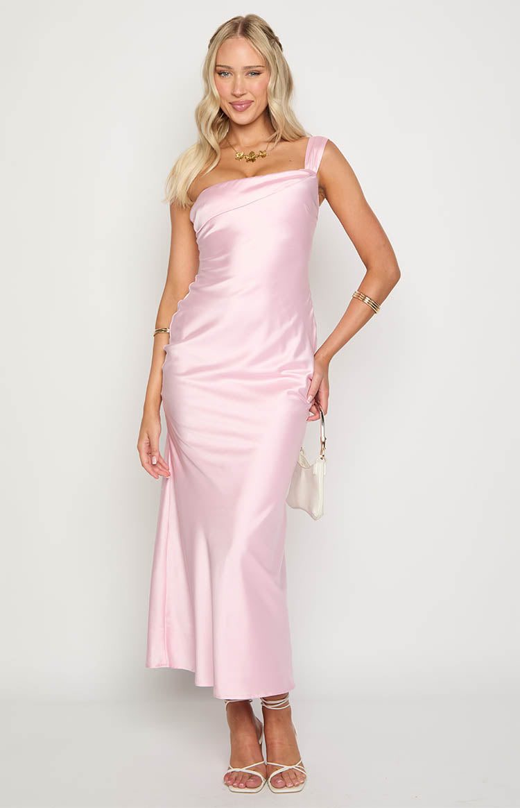 Front view of a light pink satin maxi dress featuring an asymmetrical neckline with a wide strap and draped bodice
