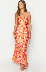 Front view of the azalea pink, orange, and red abstract floral print midi dress with a cowl neck and flowing hem
