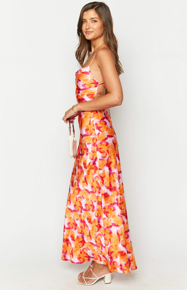 Side view showing the waist cutouts and flowy skirt of an azalea pink print midi dress