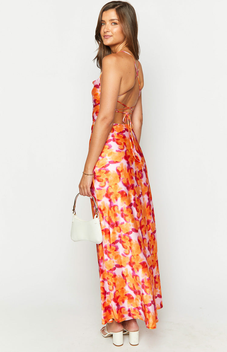 Side view of the pink and orange floral print midi dress with a low back and criss-cross tie straps