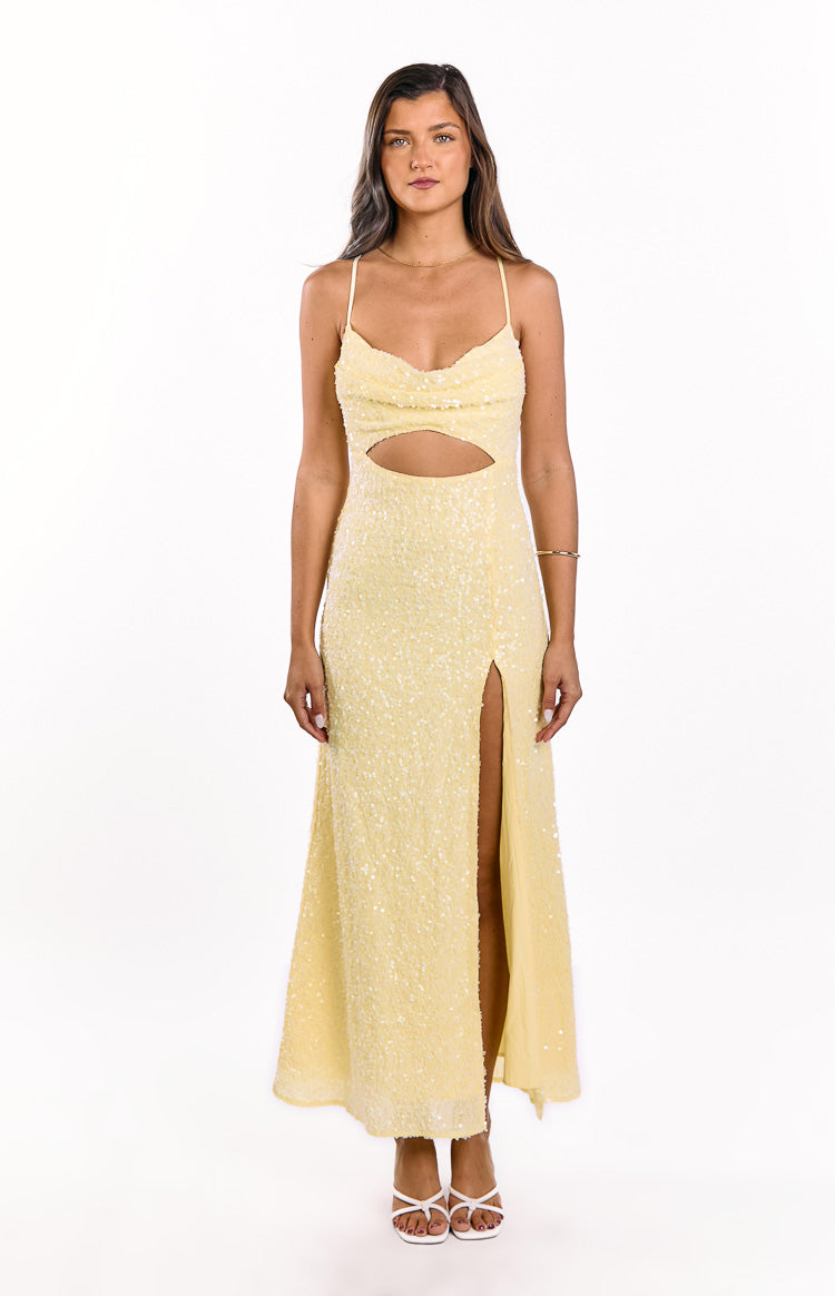 Yellow sequin maxi dress with a cowl neck, waist cutout, and a high leg slit