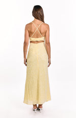 Rear view of a yellow sequin maxi dress with criss-cross back straps and a cut-out waist